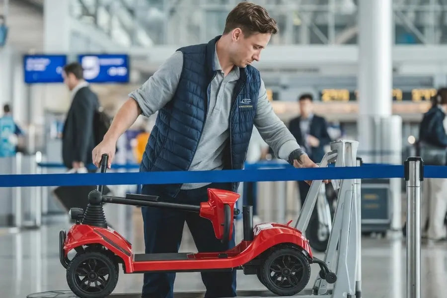During airport security checks, an airport worker is carrying a mobility scooter.