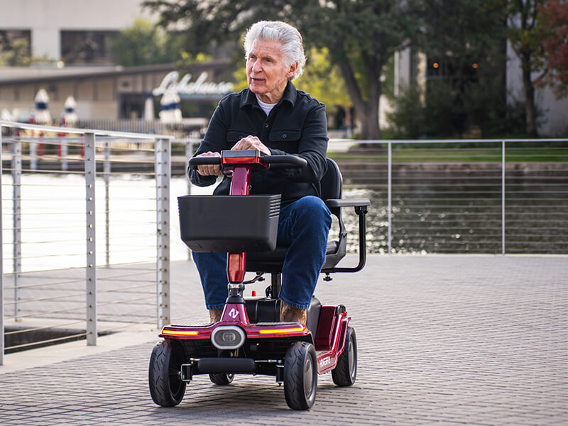 An Elderly riding hoverfly T5 mobility scooter on park