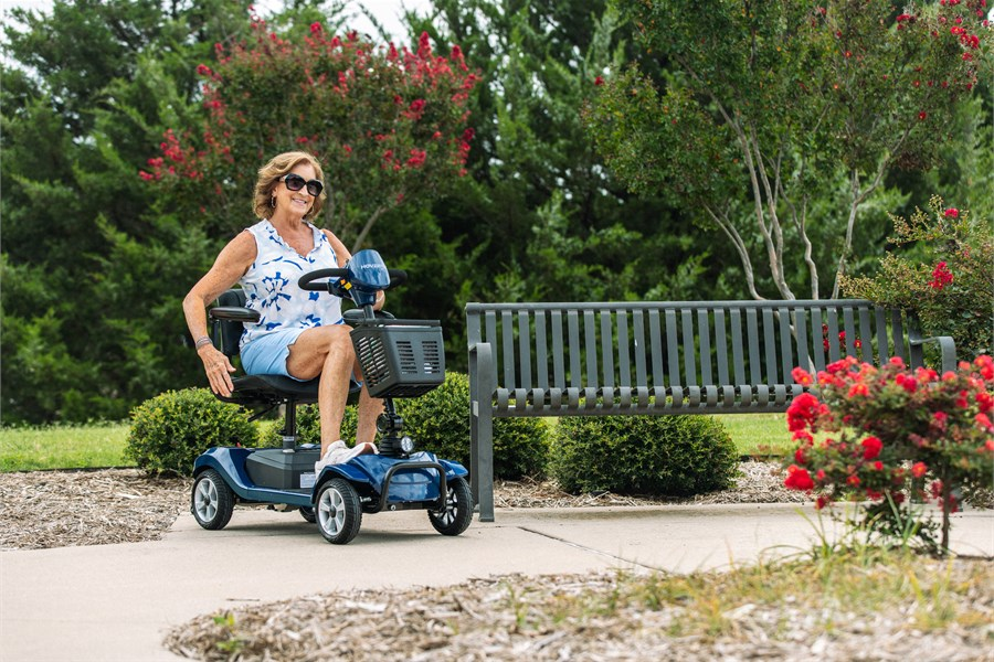 Hoverfly T4 mobility scooter in a park setting, designed for comfortable Labor Day road trips, outdoor stops, hotel corridors, and steady four-wheel travel.