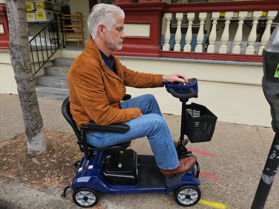 a man is driving a mobility scooter on the sidewalk